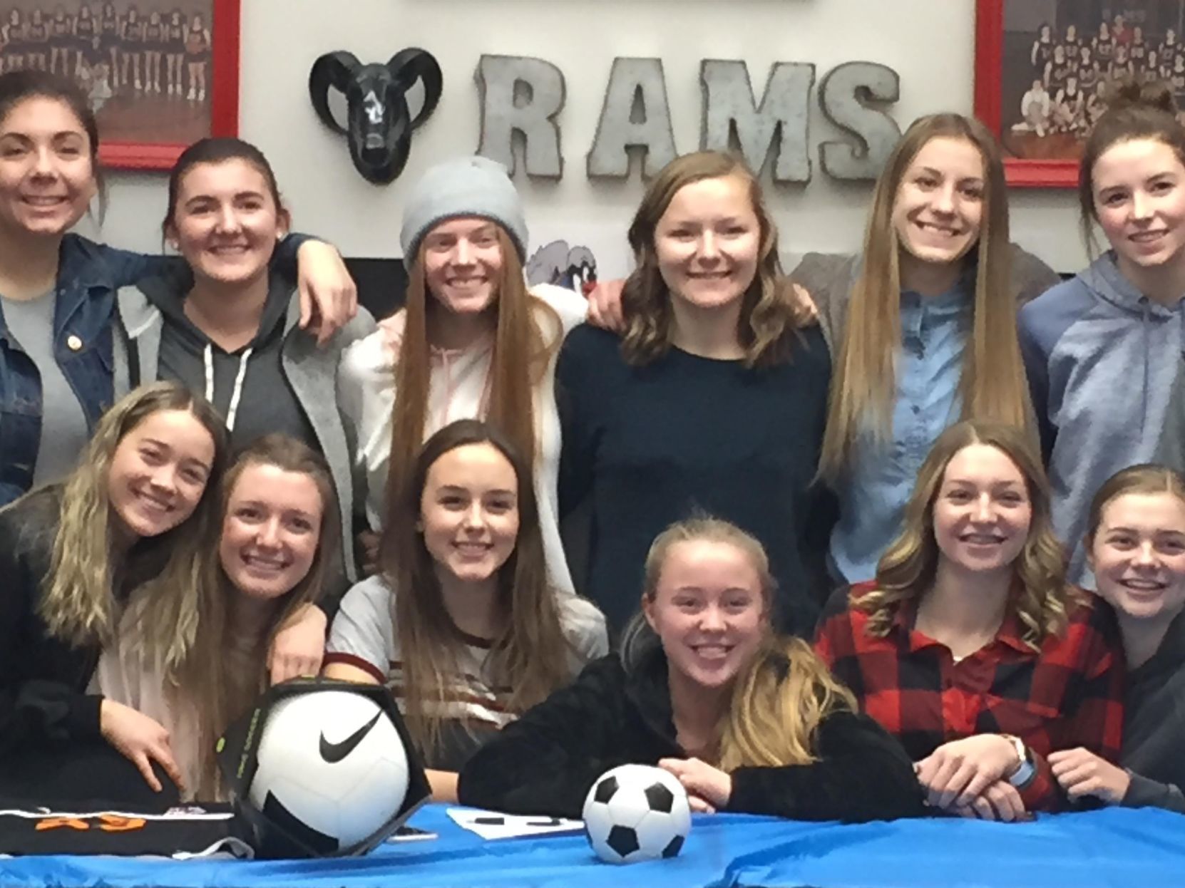 Cassidee Whitehead (back center) is surrounded by friends and family as she signs her letter of intent to play soccer for the Chukars next fall.